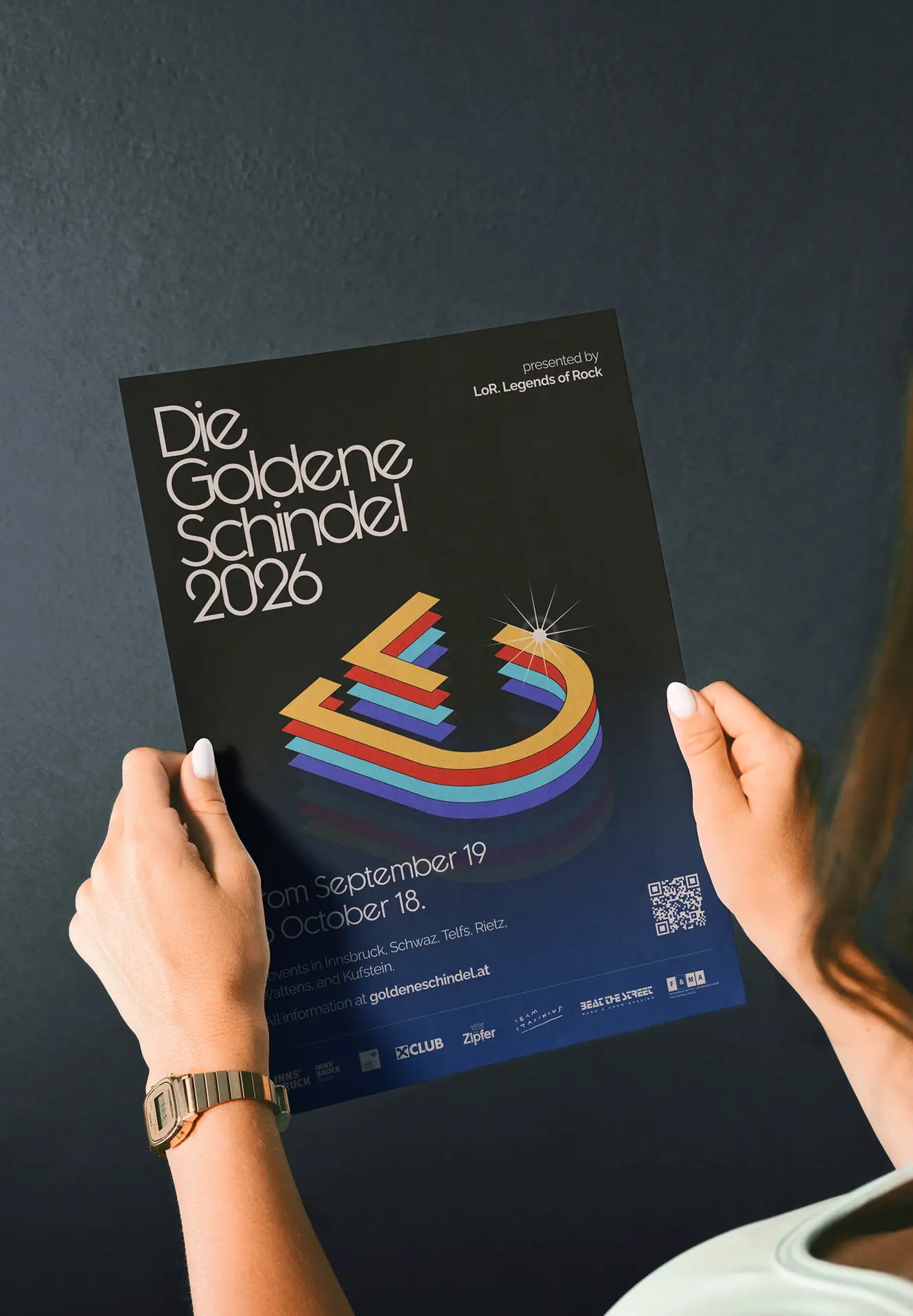 Hands holding the 2026 flyer